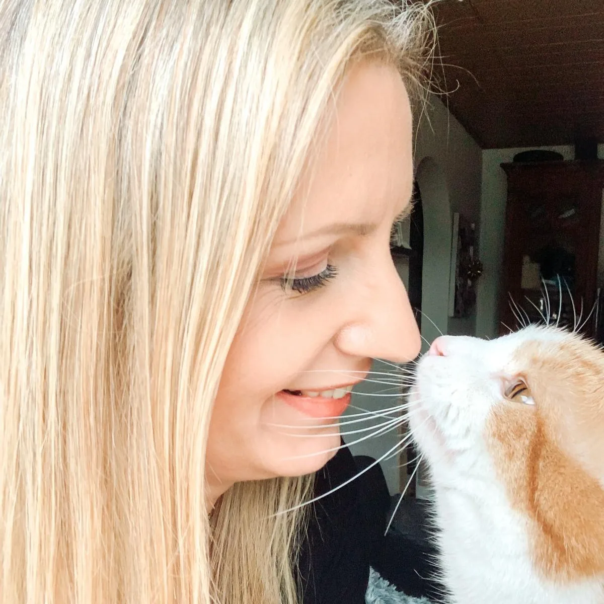 Jessica Koß Nase an Nase mit ihrer rot-weißen Katze, ein Moment tiefer Verbundenheit